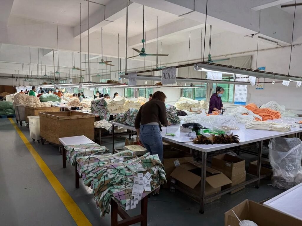 A view inside our modern knitwear factory, showcasing skilled workers operating advanced machinery in a clean, organized, and efficient production environment dedicated to quality garment manufacturing.