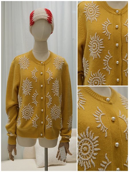 A dress form showcasing a knit gown with all-over intricate bead and sequin embroidery. The surface glimmers with a dense, floral motif, creating a tapestry of light and texture that represents the pinnacle of haute couture embellishment.