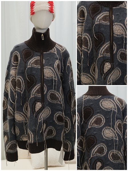 A dress form adorned with a bespoke, high-collar wool blend coat. The piece showcases intricate Aran cable knitting throughout, structured shoulders, and a tailored silhouette. The luxurious texture of the merino wool is evident, representing the pinnacle of custom craftsmanship.