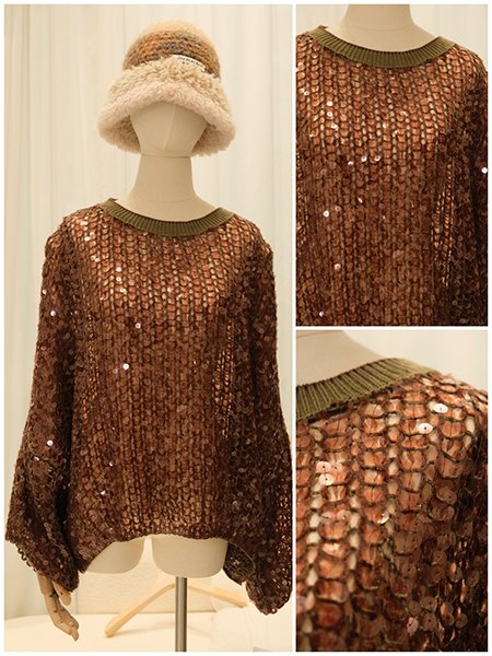 A dress form showcasing a knit gown with all-over intricate bead and sequin embroidery. The surface glimmers with a dense, floral motif, creating a tapestry of light and texture that represents the pinnacle of haute couture embellishment.The intricate beading on this dress form captures a soft, shimmering effect. Each sequin and bead is individually placed to create a fluid, luminous surface that moves with the knit's drape.