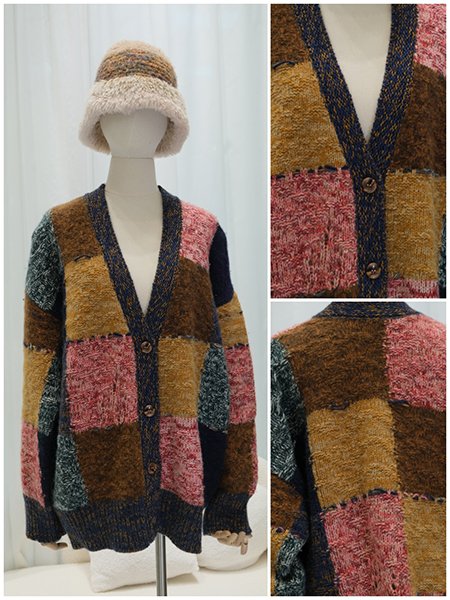 A tailored, double-breasted wool coat on a dress form, featuring a pronounced shawl collar and a sleek A-line silhouette. The piece embodies modern sophistication and precise custom tailoring.