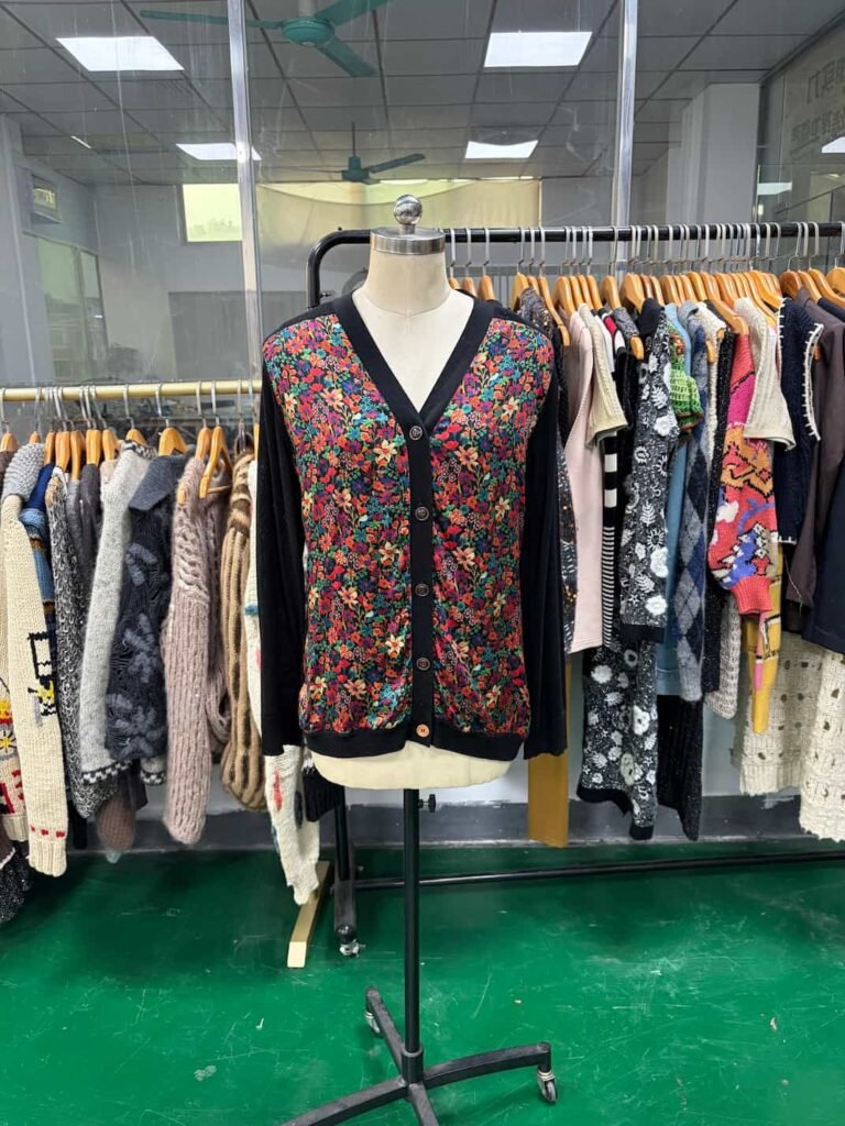 Front view of black floral print knit cardigan