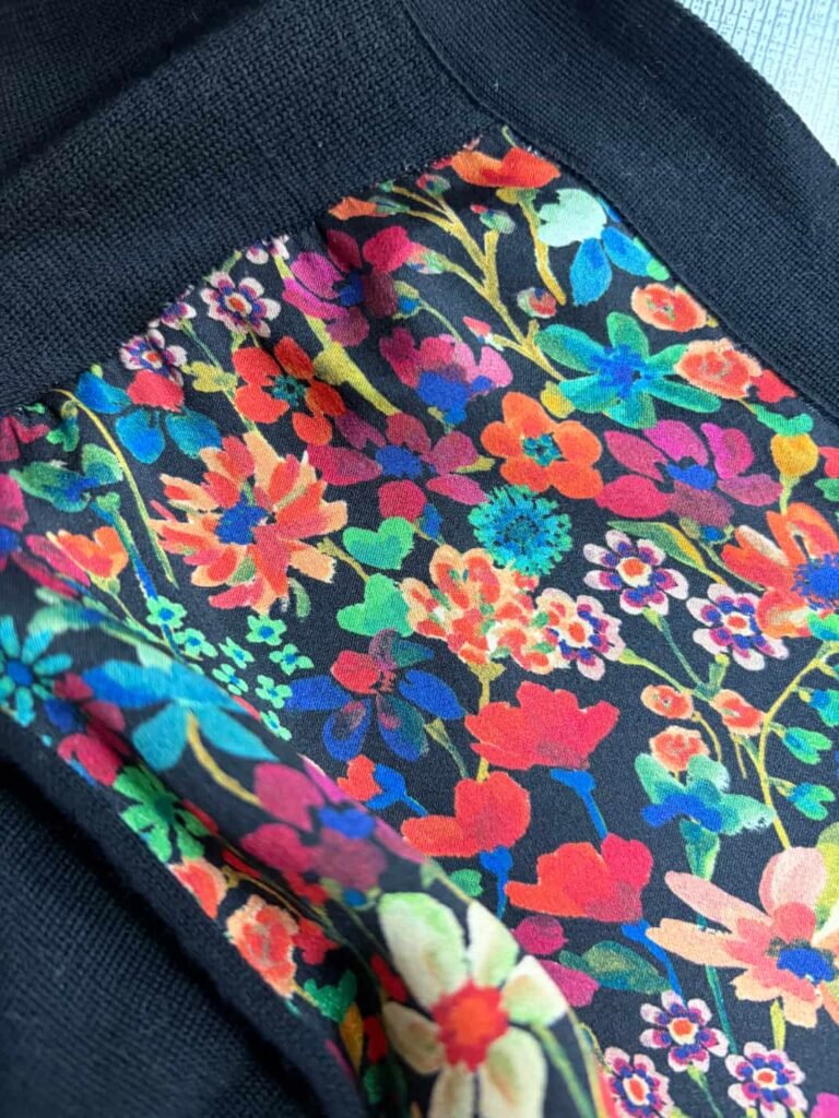 Detailed close-up of the floral pattern on knit cardigan