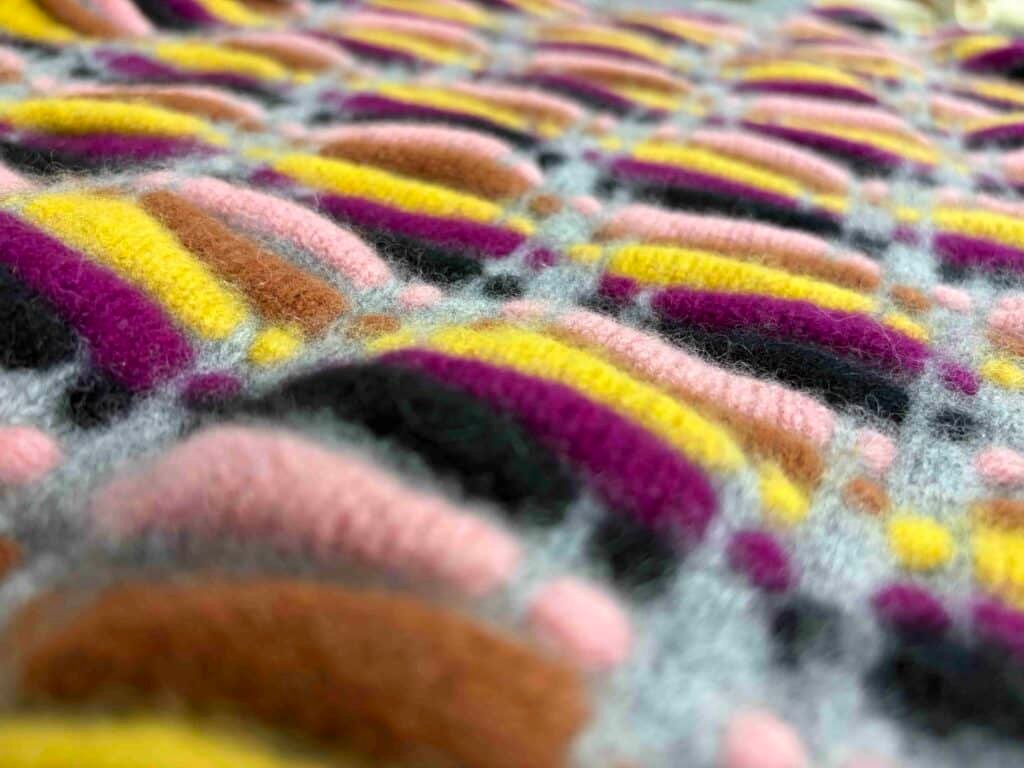 Close-up of complex patterns showing Artisanal Knitwear Craftsmanship