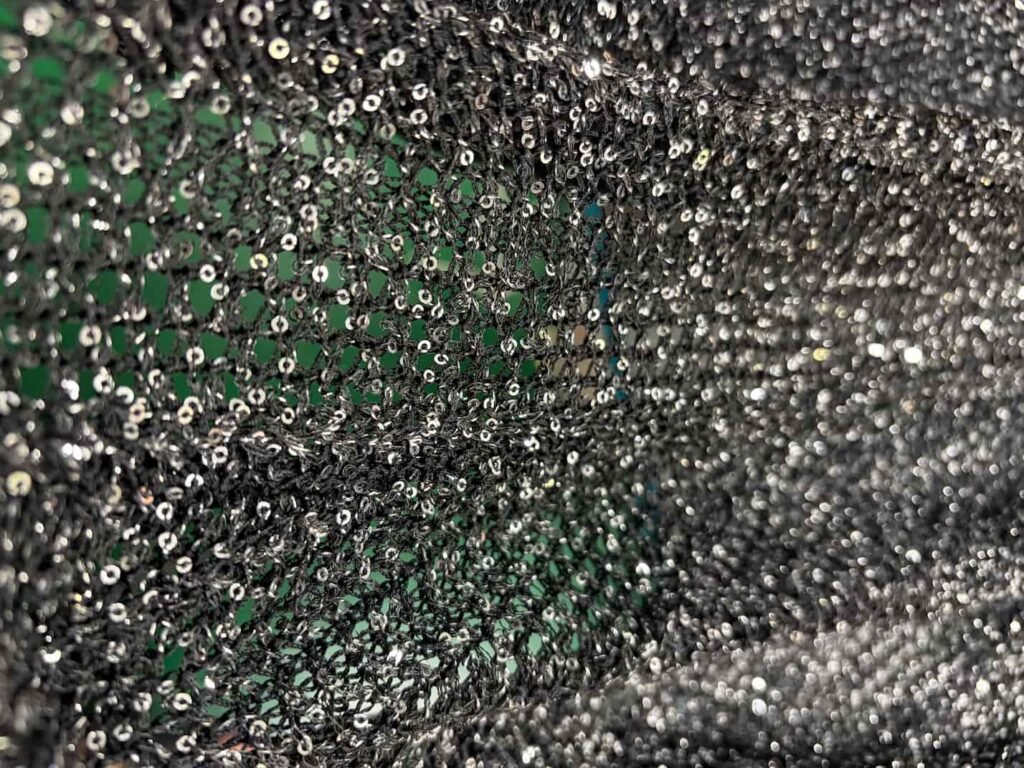 Texture of sequin fabric with knits embroidery detail