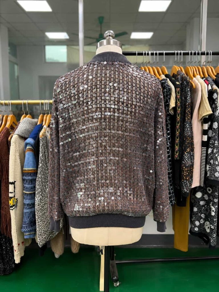 Back view of the sequin jacket featuring appliqué and cording embroidery.