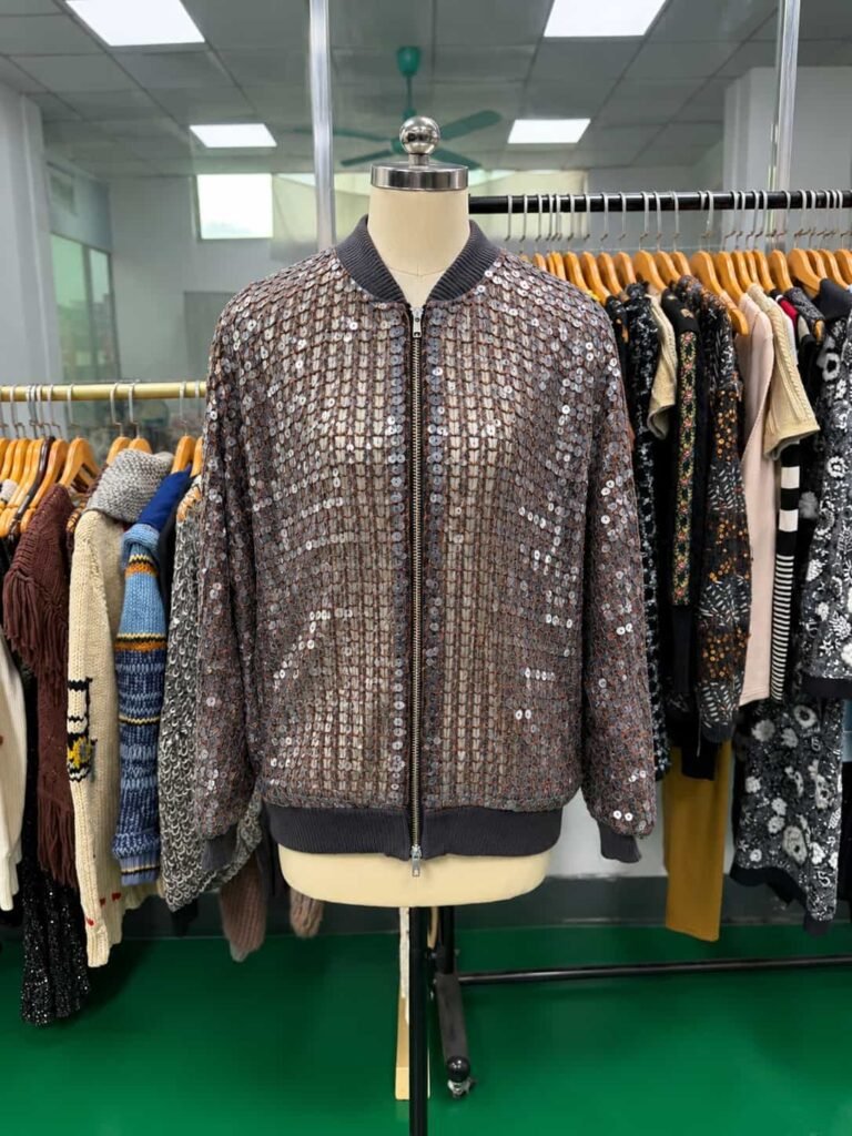 Front view of a sequin jacket with appliqué and cording embroidery.